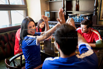 football fans with beer celebrating victory at bar