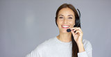 Adorable call center agent speaking with someone on headset