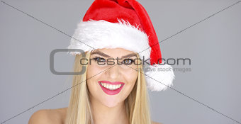 Beautiful chick in Santa Claus Hat posing with sensual smile