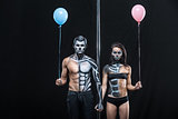 Couple of dancers with body-art and balloons
