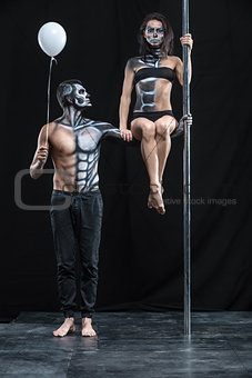 Couple of dancers with body-art and balloon