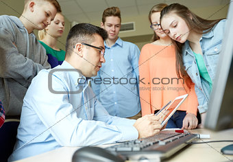students and teacher with tablet pc at school