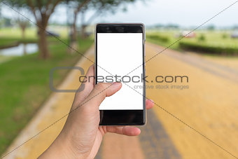 Left hand holds mobile phone with black white background