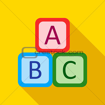 Children's toy cubes with letters on a yellow background