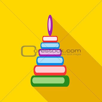Children's toy pyramid on a yellow background