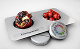 Close up of pomegranate and pills isolated - vitamin concept