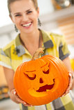 Closeup on housewife showing big pumpkin Jack-O-Lantern