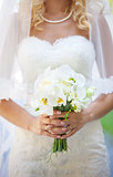 Cropped view of elegant bride holding flowers