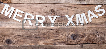 Merry Christmas sign on wooden background