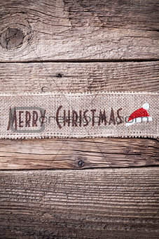 Christmas ribbon on wooden background 