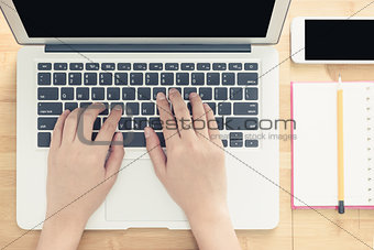 Top view of woman hand working on laptop