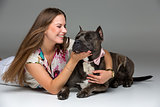 Beautiful girl with grey stafford terrier