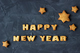 background with baked gingerbread stars and words happy new year. creative idea
