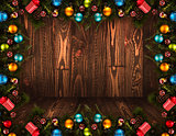 2017 Happy New Year seasonal background with real wood green pine, colorful Christmas baubles, gift boxe and other seasonal stuff over an old wooden aged background