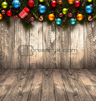 2017 Happy New Year seasonal background with real wood green pine, colorful Christmas baubles, gift boxe and other seasonal stuff over an old wooden aged background