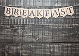 Breakfast sign with paper letter on wooden table