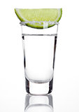 Silver tequila shot glass with lime slice and salt