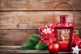 Christmas time red latern with candle light and holiday decorati