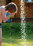 Boy with Blond Hair Washing at Outdoor Shower