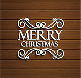 Merry Christmas on wooden background.
