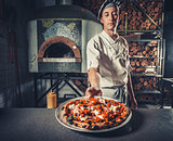 male cook holding delicious appetizer