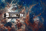 Space Shuttle flight over space nebula.