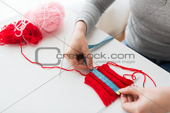 woman with knitting, needles and measuring tape