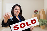 Hispanic Female Real Estate Agent with Sold Sign and Keys in Roo