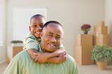 African American Father and Son In Room with Packed Moving Boxes