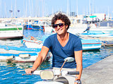 Young Italian Man on Vespa Scooter Smiling