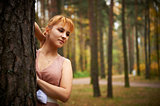 Pretty girl in autumn forest.