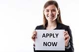 young business woman holding an apply now sign