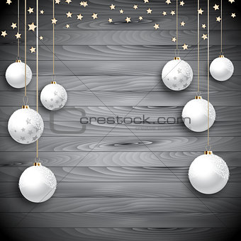 Hanging Christmas baubles on a wooden background