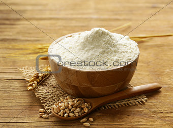 Natural organic wheat flour. Grain on a wooden table