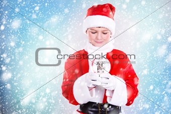 boy dressed up as Santa in winter setting