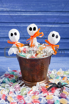 Halloween candy bucket, lollipop ghosts and rubber spider