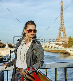 fashion-monger with shopping bags in Paris, France looking aside