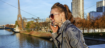 Woman looking into distance and speaking on cell phone, Paris