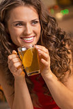 Happy young woman drinking ginger tea with lemon