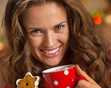 smiling young woman with cup of hot chocolate and ch