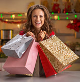 Smiling young woman with christmas shopping bags in christmas de
