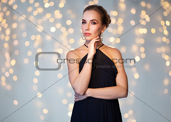 beautiful woman in black wearing diamond jewelry