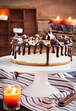 Two-ply chocolate cheesecake decorated with candies and frosting