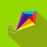 A child's toy a kite on a bright green background