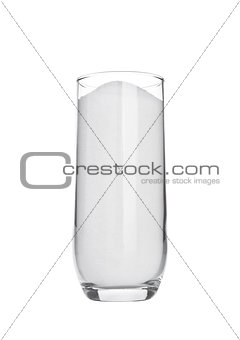 Glass of white sugar isolated on white