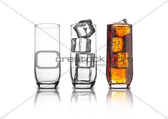 Glass of cola with ice cubes and empty glasses