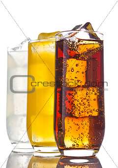 Glasses with cola orange soda and lemonade ice