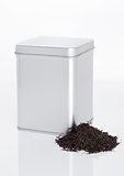 Black tea steel jar with loose tea next to it