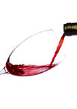 Pouring red wine from bottle to glass isolated