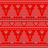 Red Holiday seamless pattern with cross stitch embroidered fir-tree and hearts.